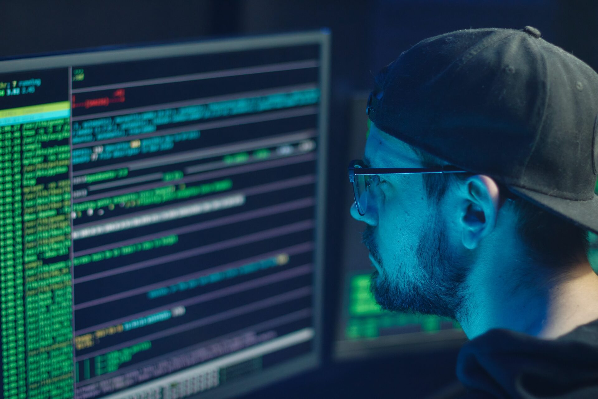 A person looking at computer code on a screen. A person looking at computer code on a screen.